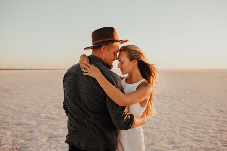 pink Lemurian lake, romantic photoshoot of young couple in love
